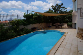 Apartment with a garden, BBQ and a swimming pool.